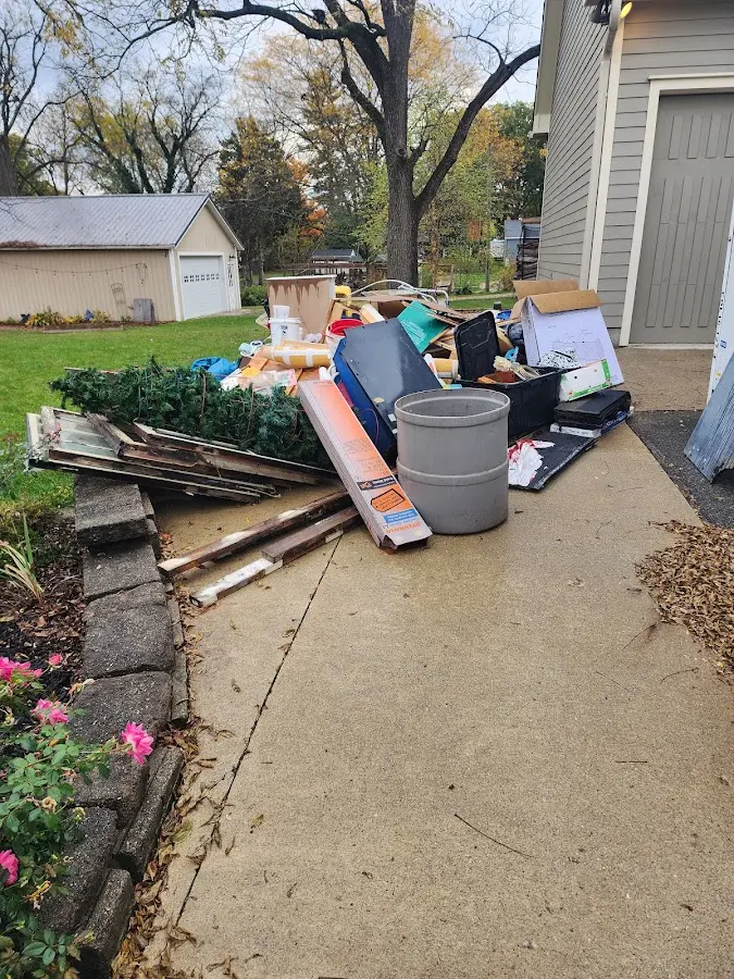 Dumpster being loaded with debris for 12 Yard Dumpster Rental in Riverview